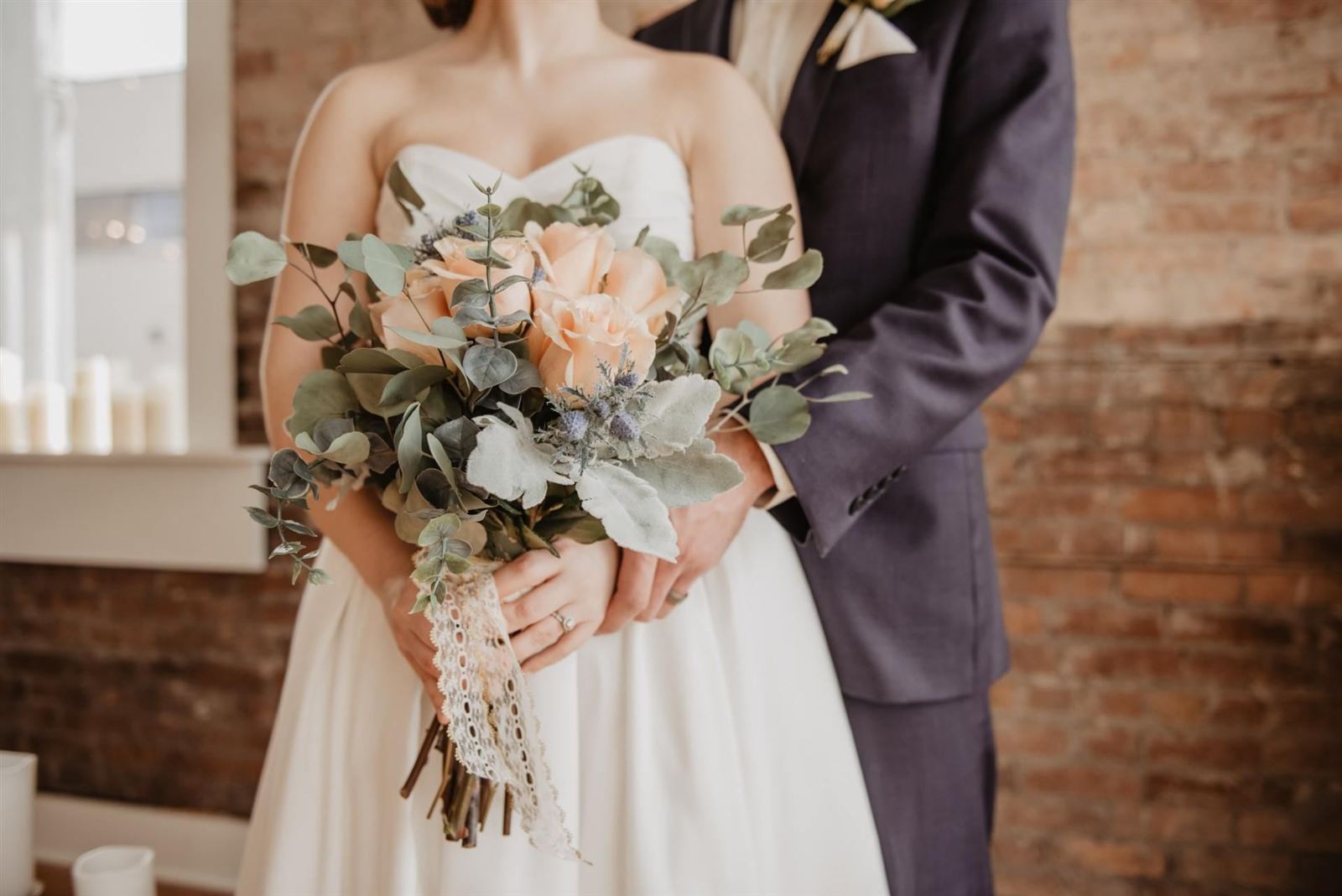 Bride and groom holding a bouquet